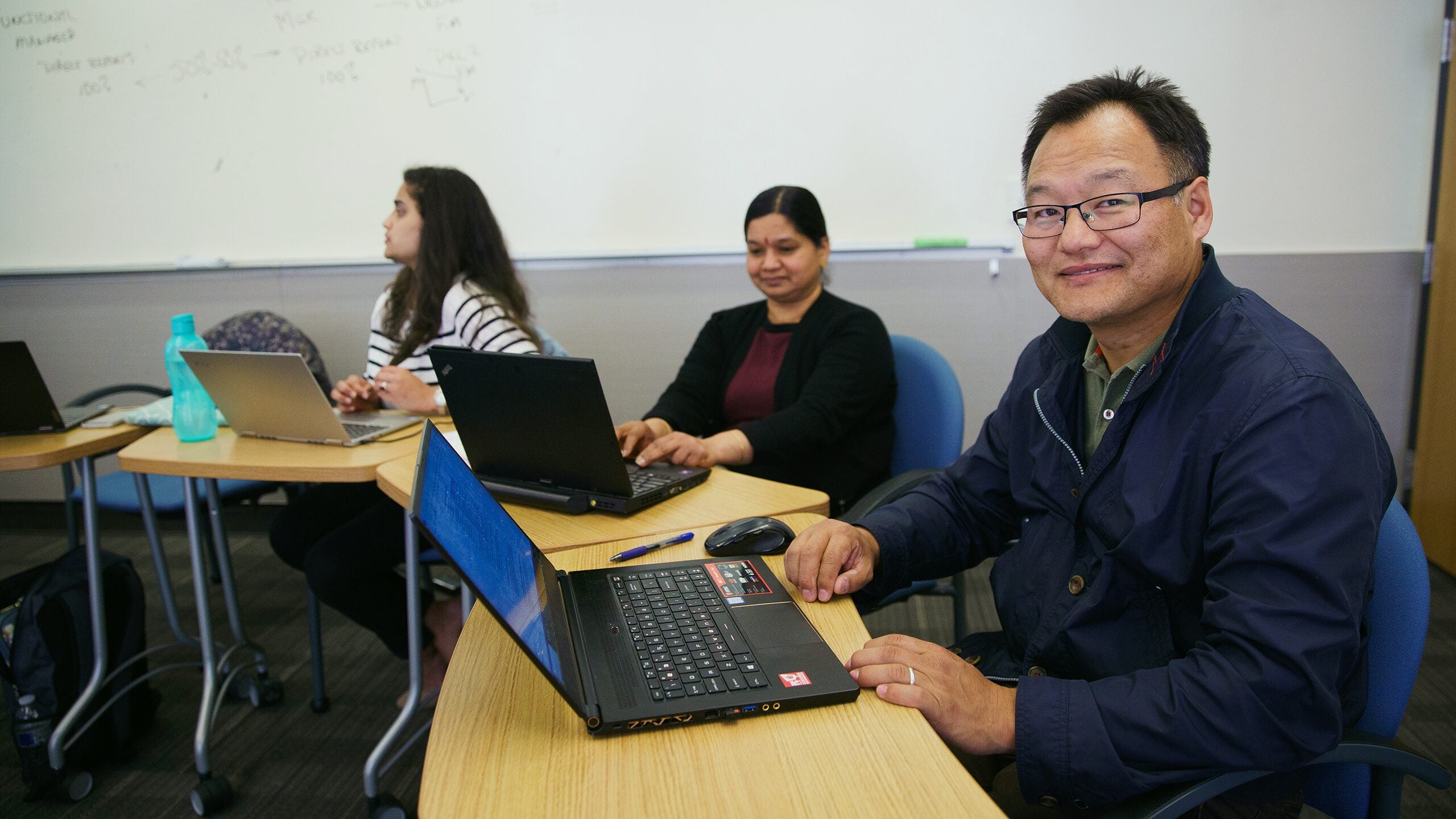 Students in the classroom working on a laptops.